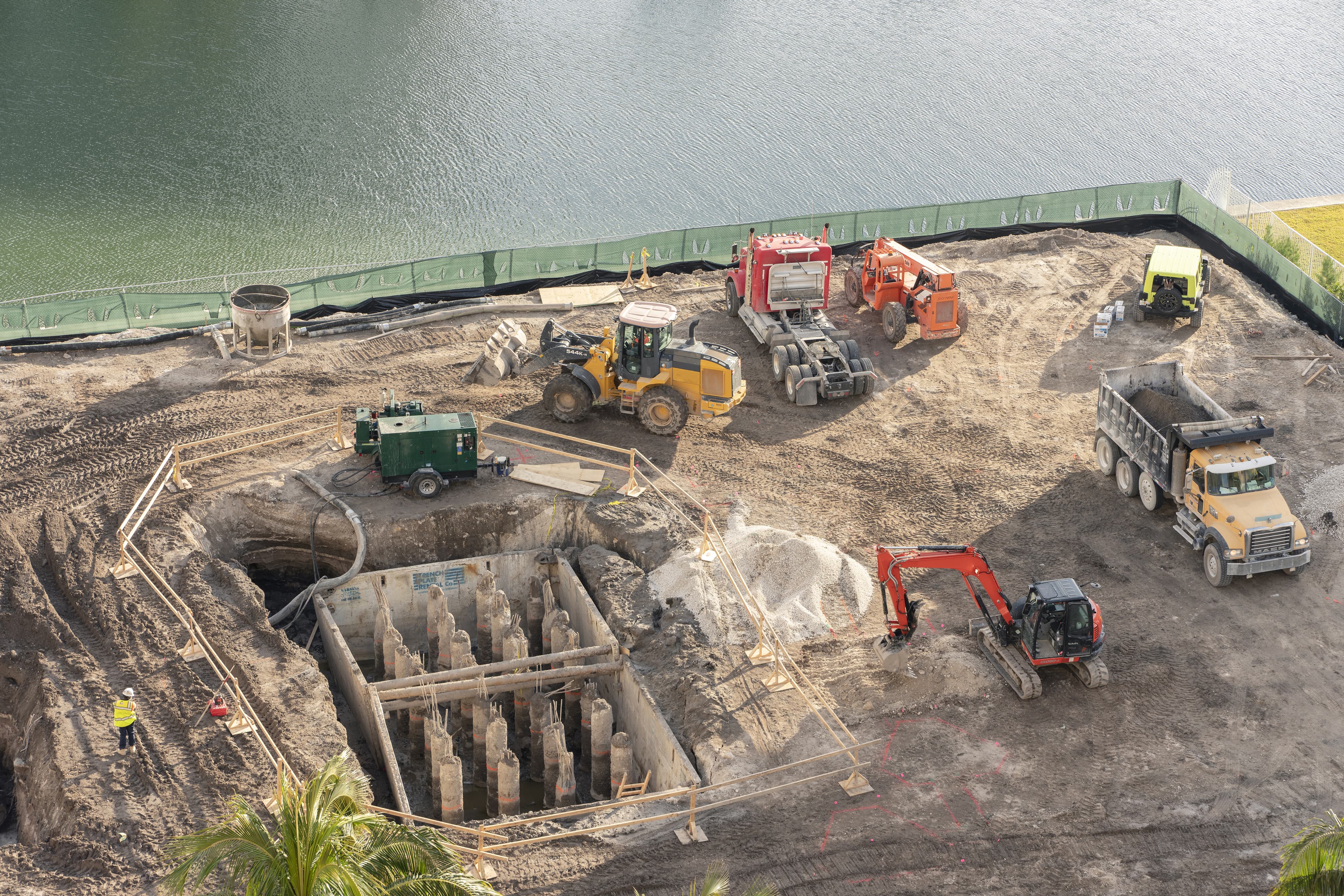 construction site with dirt and dump trucks